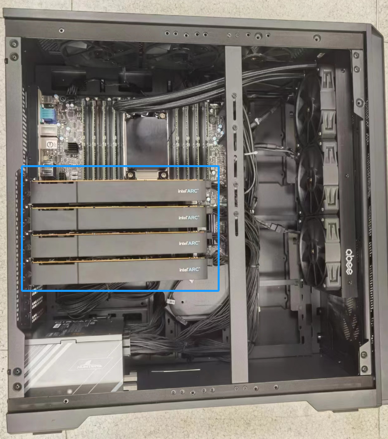 A black computer case with many wires and wires Description automatically generated with medium confidence